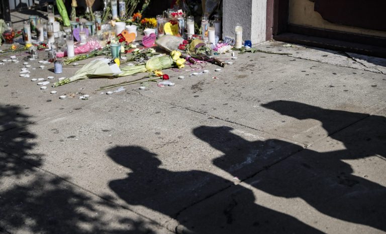 Mourners gather outside Ned Peppers bar that was the scene of a mass shooting the previous day, Monday, Aug. 5, 2019, in Dayton, Ohio. 