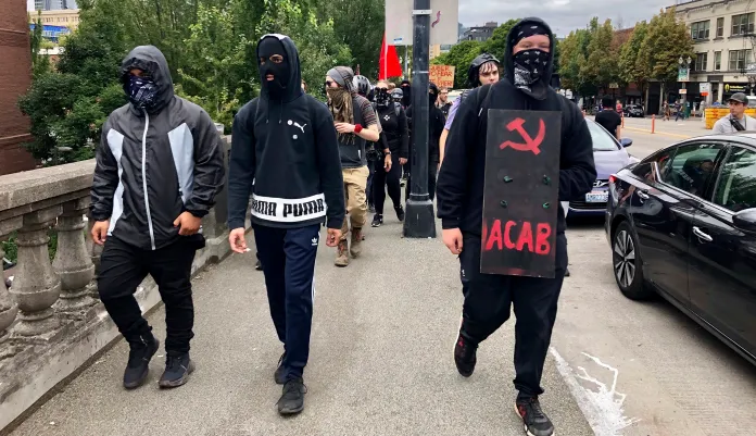 Anti-fascist counterdemonstrators cross the Burnside Bridge across the Willamette River from the west side of the city to the east side in search of the far-right group, the Proud Boys, in Portland, Oregon, on Saturday. Self-described anti-fascists vowed to confront the rally while leaders from the far right urged their followers to turn out in large numbers to protest the arrests of multiple members of right-wing groups in the run-up to the event. Antifa members often cover their faces with masks, making it harder to identify them.