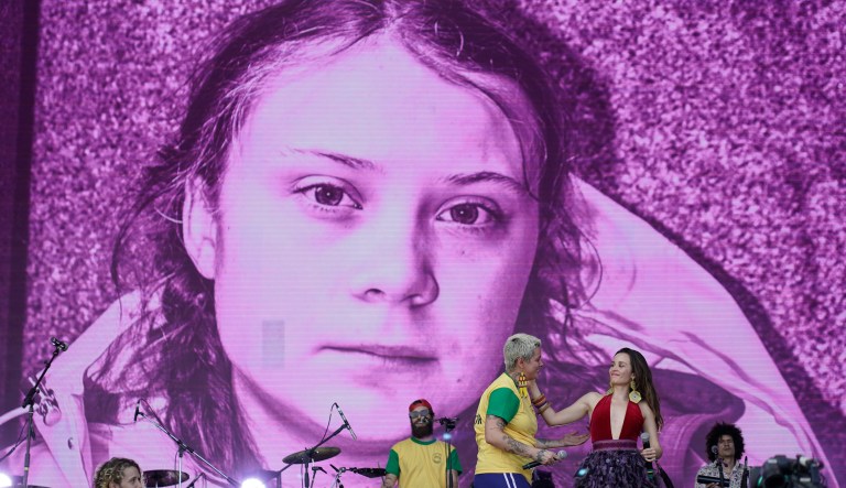 A picture of the Swedish activist and student Greta Thunberg is displayed on the big screen as Juliana Strassacapa of the Brazilian band Francisco, el Hombre and Catalina Garcia, of the Colombian band Monsieur Perine, right, perform at the Rock in Rio music festival in Rio de Janeiro, Brazil, Thursday, Oct. 3, 2019.