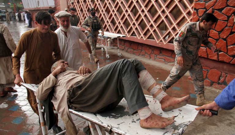 A wounded man is brought by stretcher into a hospital after a mortar was fired by insurgents in Haskamena district of Jalalabad east of Kabul, Afghanistan, Friday, Oct. 18, 2019. An Afghan official says at least several people have been killed during Friday prayers when a mortar fired by insurgents blasted through the roof of a mosque.