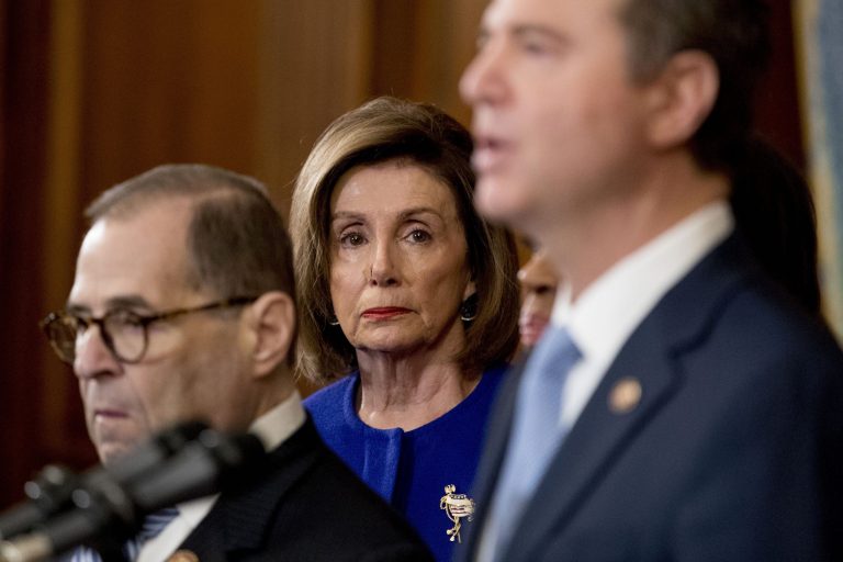 House Speaker Nancy Pelosi of Calif., center, and Chairman of the House Judiciary Committee Jerrold Nadler, D-N.Y., left, listen as Adam Schiff, D-Calif., Chairman of the House Intelligence Committee, foreground, speaks during a news conference to unveil articles of impeachment against President Donald Trump, abuse of power and obstruction of Congress.