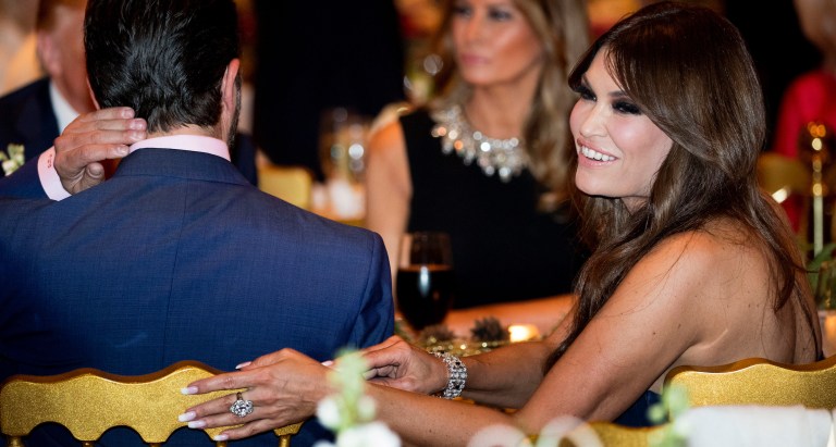 Kimberly Guilfoyle, right, and Donald Trump Jr., the son of President Donald Trump, left, sit with President Donald Trump, background left, and first lady Melania Trump, center, during Christmas Eve dinner at Mar-a-lago in Palm Beach, Fla., Tuesday, Dec. 24, 2019. (AP Photo/Andrew Harnik)