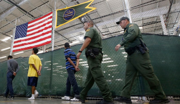 Young detainees being escorted to an area to make phone calls as hundreds of mostly Central American immigrant children are being processed and held at the U.S. Customs and Border Protection Nogales Placement Center in Nogales, Ariz.