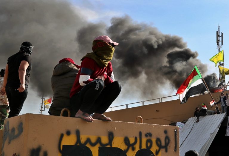 Pro-Iranian militiamen and their supporters set a fire during a sit-in in front of the U.S. Embassy in Baghdad, Iraq.