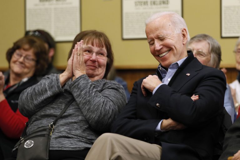 Democratic presidential candidate former Vice President Joe Biden listens to his wife Jill speak during a community event at the National Motorcycle Museum, Thursday, Jan. 2, 2020, in Anamosa, Iowa. (AP Photo/Charlie Neibergall)