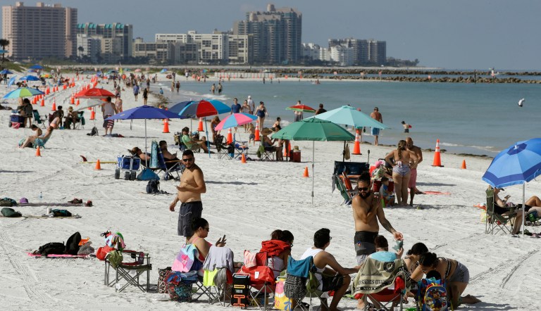 Cones are set up to help beachgoers keep a safe distance from one another after Clearwater Beach officially reopened to the public Monday, May 4, 2020, in Clearwater Beach, Fla. Many public beaches and restaurants are reopening as part of Florida Gov. Ron DeSantis' plan to stop the spread of the coronavirus.