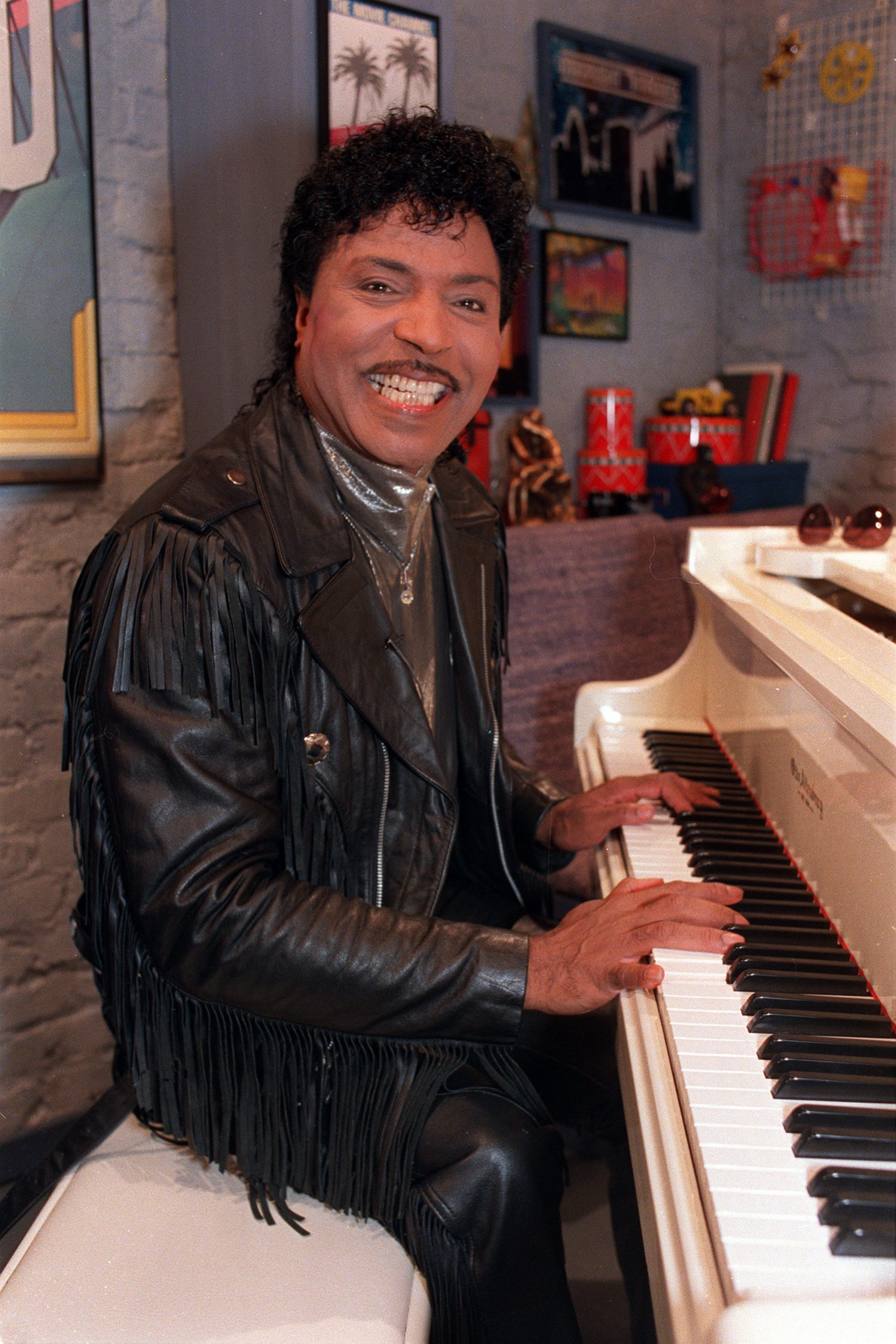 In this Jan. 22, 1988, file photo, Little Richard plays the piano during taping at The Movie Channel Inc., in New York. Little Richard, the self-proclaimed “architect of rock ‘n’ roll” whose piercing wail, pounding piano, and towering pompadour irrevocably altered popular music while introducing black R&B to white America, died on Saturday.