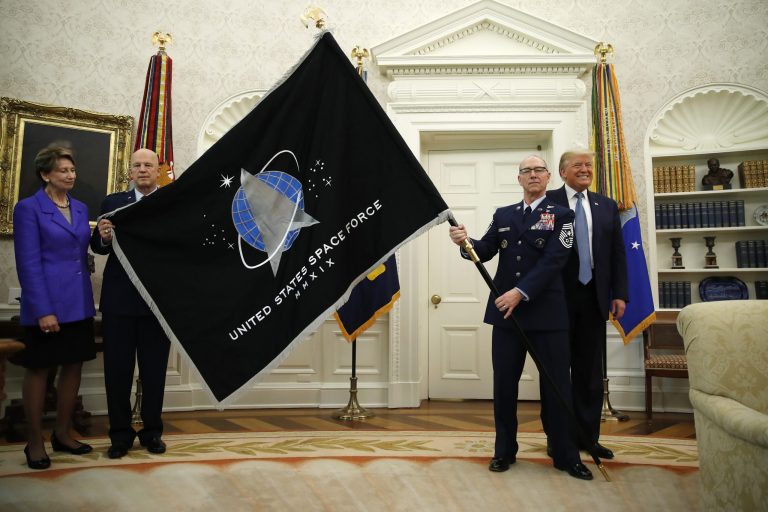 President Donald Trump stands in the Oval Office during the presentation of the United States Space Force Flag in the White House, Friday, May 15, 2020, in Washington.