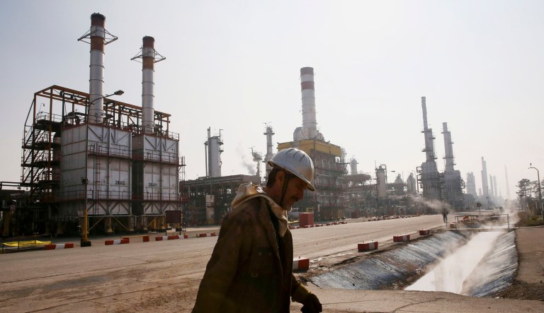 An Iranian oil worker makes his way through Tehran's oil refinery south of the capital Tehran, Iran.