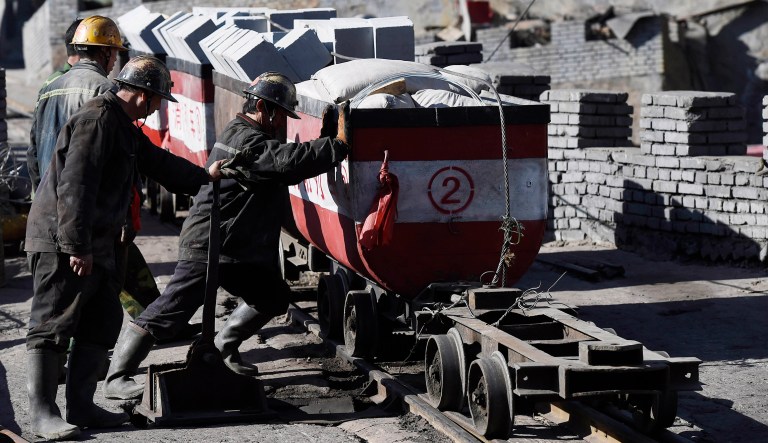 In this April 22, 2015 photo released by China's Xinhua News Agency, rescuers transport relief materials into the Jiangjiawan mine near the northern city of Datong, China's Shanxi Province. Search teams have recovered the bodies of more than 20 Chinese coal miners who died when the shaft where they were working filled with water, an official said Thursday.