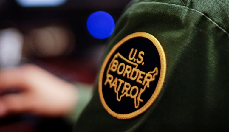 In this June 5, 2014 photo, a Border Patrol agent uses a headset and computer to conduct a long distance interview by video with a person arrested crossing the border in Texas, from a facility in San Diego. Hit with a dramatic increase of Central Americans crossing in South Texas, the Border Patrol is relieving staffing woes by enlisting agents in less busy sectors to process arrests through video interviews. 
