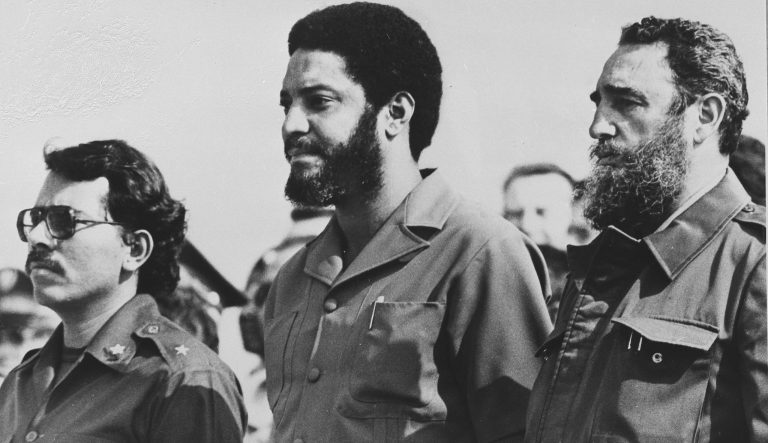 In this May 1, 1980 photo, then Grenada's Prime Minister Maurice Bishop, center, is flanked by Cuba's leader Fidel Castro, right, and Nicaragua's President Daniel Ortega in Havana, Cuba. 