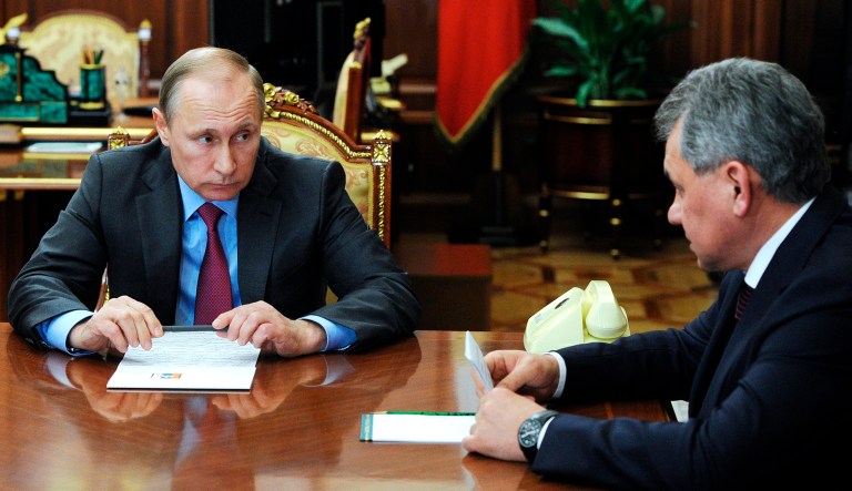 Russian President Vladimir Putin, left, listens to Russian Defense Minister Sergey Shoygu during a meeting in the Kremlin in Moscow.