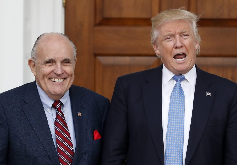President-elect Donald Trump calls out to media as he and former New York Mayor Rudy Giuliani pose for photographs as Giuliani arrives at the Trump National Golf Club on Nov. 20, 2016, in Bedminster, New Jersey.