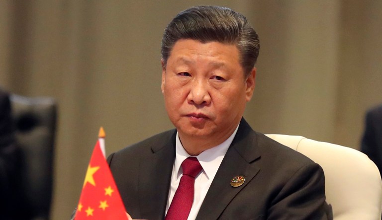 China's President Xi Jinping takes his seat for the first closed session of the BRICS summit, in Johannesburg, South Africa. 