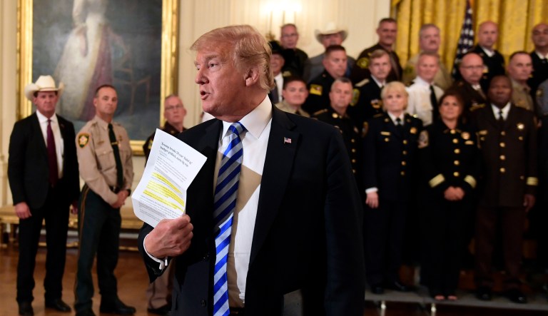 President Trump responds to a reporters question during an event with sheriffs in the East Room of the White House in Washington.