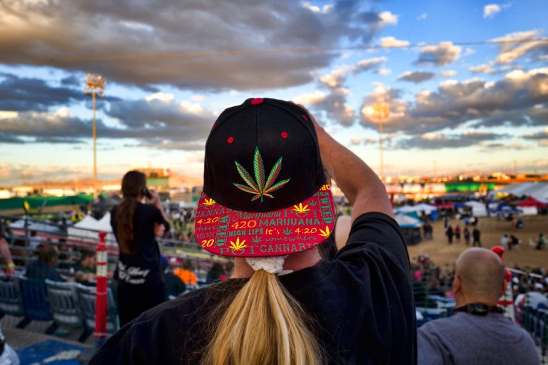 In this 2018 photo, an attendee takes a photo at Adelanto Stadium during the cannabis-themed Kushstock Festival at Adelanto, California.