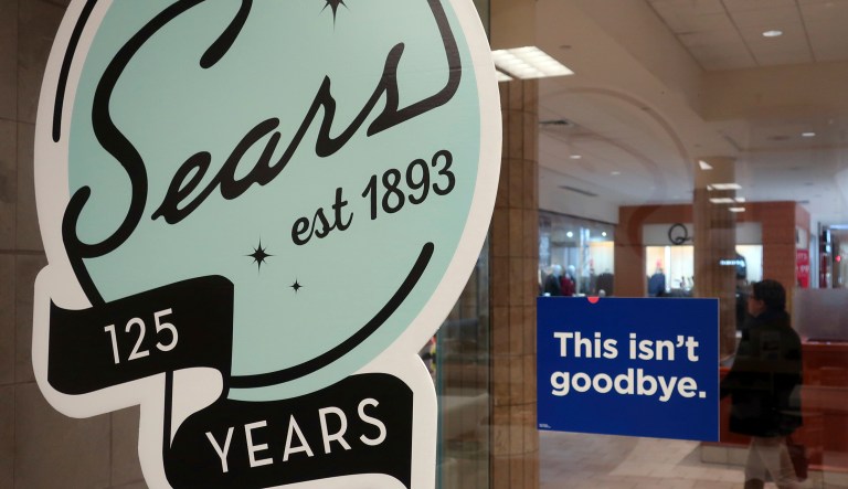 In this Nov. 2, 2018 photo, a sign in the window at Sears promises that "This isn't goodbye," at the Livingston Mall in Livingston, N.J. Sears is closing 80 more stores as it teeters on the brink of liquidation. The 130-year old retailer set a deadline of Friday, Dec. 28, 2018 for bids for its remaining stores to avert closing down completely.