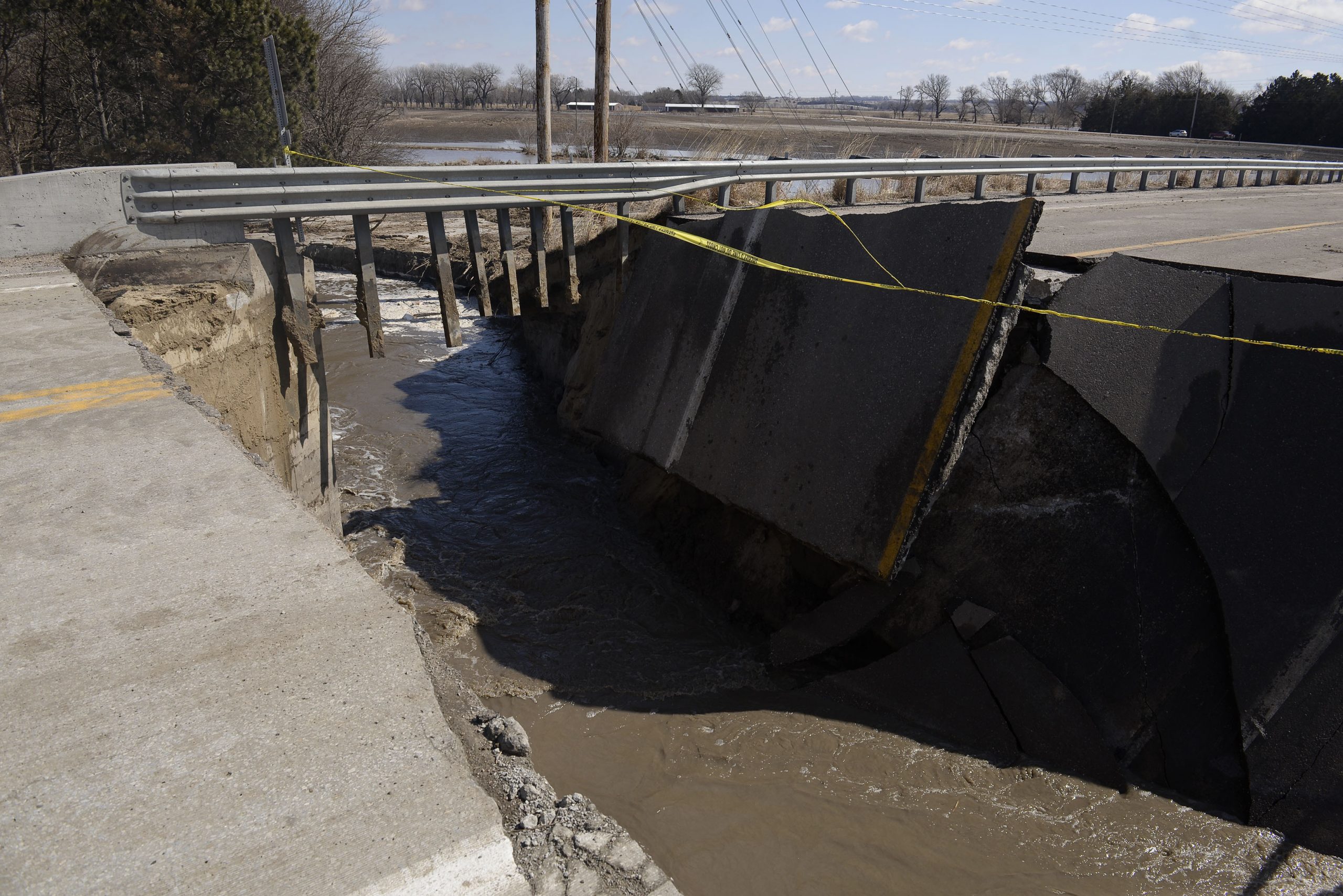The approach to a bridge over the Elkhorn River, seen Friday afternoon, March 15, 2019, leading south out of Stanton, Neb., collapsed because of the flooding on Thursday. Thousands of people have been urged to evacuate along eastern Nebraska rivers as a massive late-winter storm system has pushed streams and rivers out of their banks throughout the Midwest. 