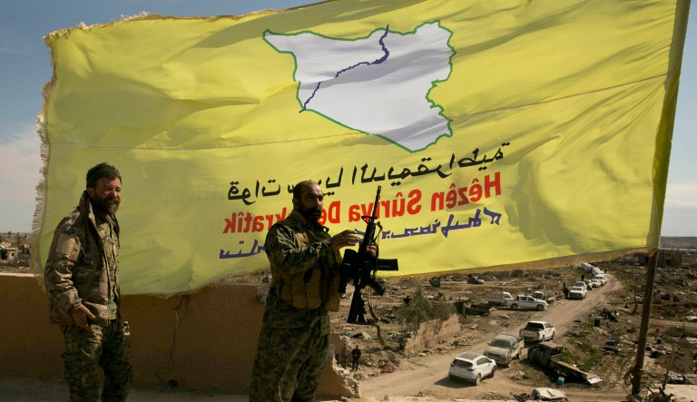 U.S.-backed Syrian Democratic Forces (SDF) fighters pose for a photo on a rooftop overlooking Baghouz, Syria, after the SDF declared the area free of Islamic State militants after months of fighting on Saturday.