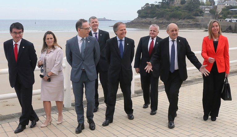 Japanese Foreign Minister Taro Kono, Canada's Foreign Minister Chrystia Freeland, Germany's Foreign Minister Heiko Maas, Britain's Director General for Political Affairs at the Foreign & Commonwealth Office Richard Moore, Italy's Foreign Minister Enzo Moavero Milanesi, US Deputy Secretary of State John J. Sullivan, French Foreign Minister Jean-Yves Le Drian and European Union High Representative for Foreign Affairs and Security Policy Federica Mogherini, from left to right, walk for a group photo on the second day of a G7 meeting at ministerial level in Dinard, Brittany, Saturday, April 6, 2019. The G7 meeting is focus on cybersecurity, the trafficking of drugs, arms and migrants in Africa's troubled Sahel region, and fighting gender inequality. 