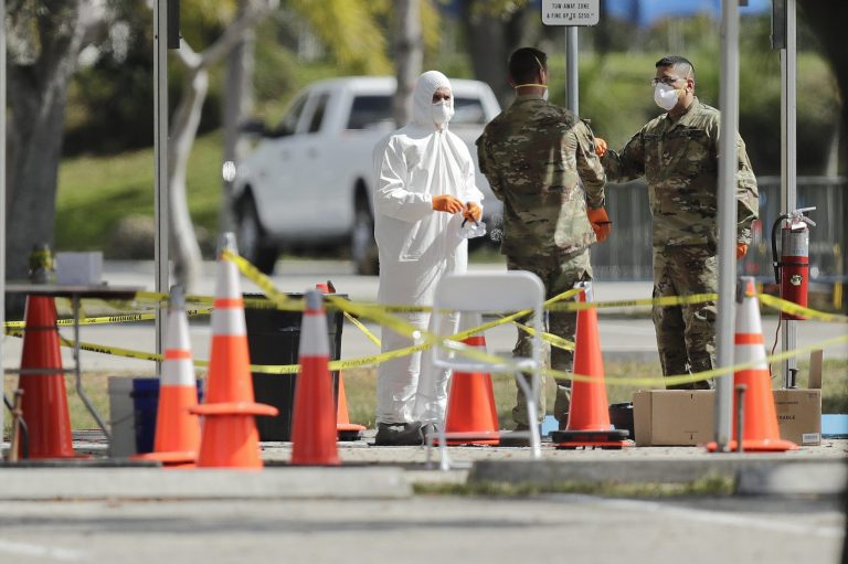 Members of the National Guard prepare a drive-thru COVID-19 testing site at C.B. Smith Park, Thursday, March 19, 2020, in Pembroke Pines, Fla.
