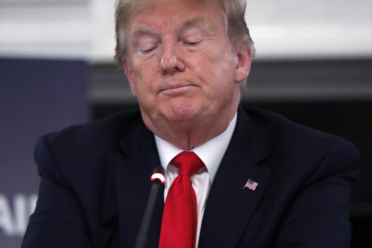 President Donald Trump listens during a roundtable with industry executives about reopening country after the coronavirus closures, in the State Dining Room of the White House, Friday.