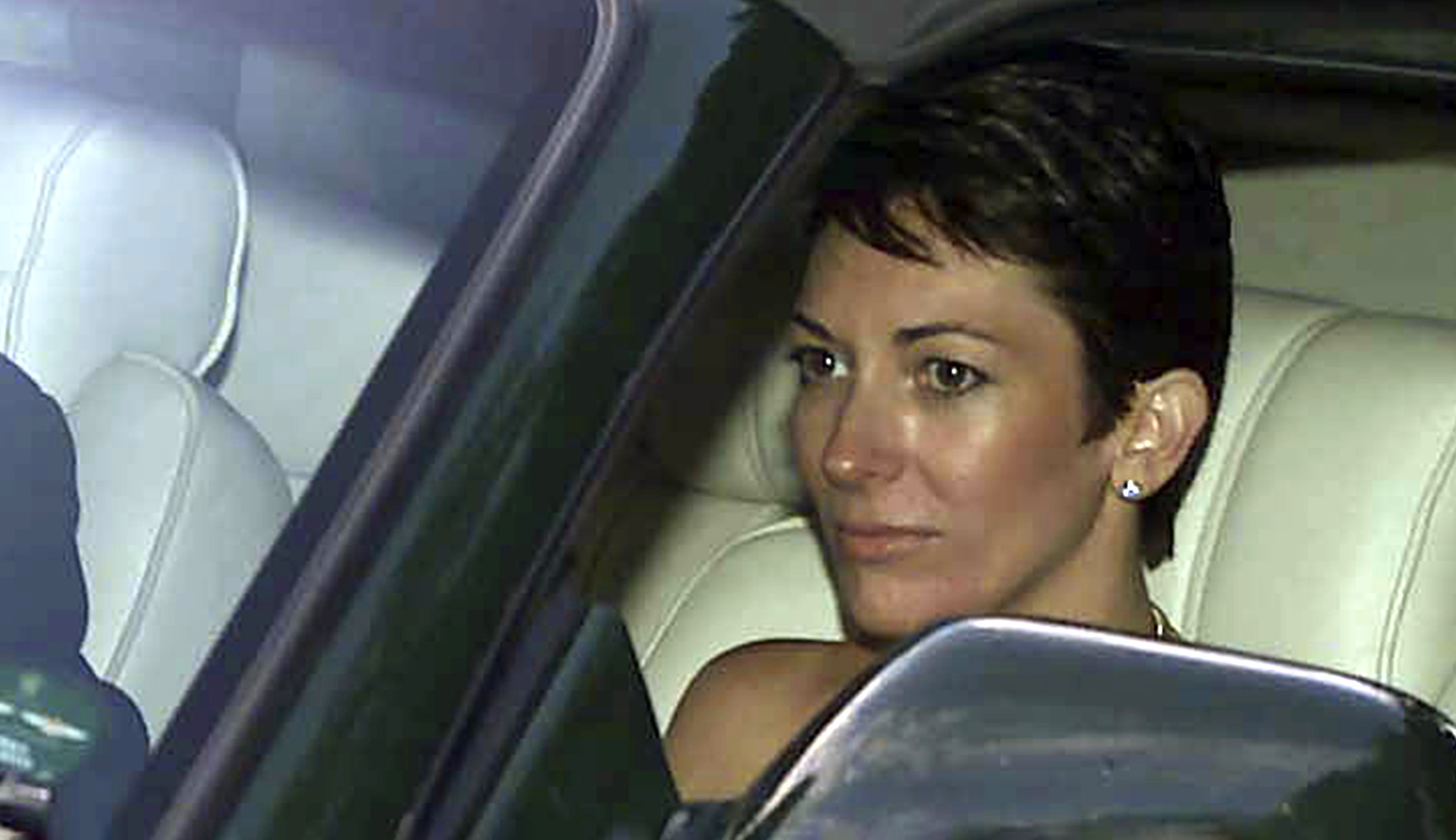 In this Sept. 2, 2000 file photo, British socialite Ghislaine Maxwell, driven by Britain's Prince Andrew leaves the wedding of a former girlfriend of the prince, Aurelia Cecil, at the Parish Church of St Michael in Compton Chamberlayne near Salisbury, England. The FBI said Thursday July 2, 2020, Ghislaine Maxwell, who was accused by many women of helping procure underage sex partners for Jeffrey Epstein, has been arrested in New Hampshire.