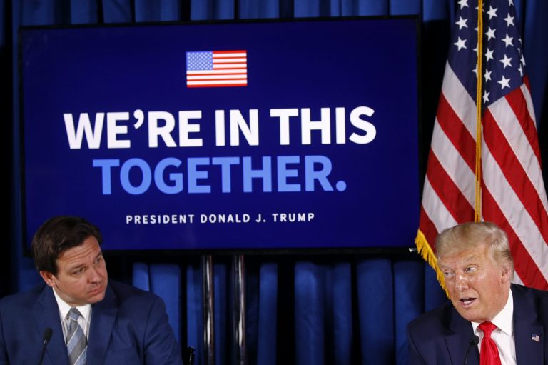 President Donald Trump speaks alongside Florida Gov. Ron DeSantis during a roundtable discussion on the coronavirus outbreak and storm preparedness at Pelican Golf Club in Belleair, Fla., Friday, July 31, 2020.