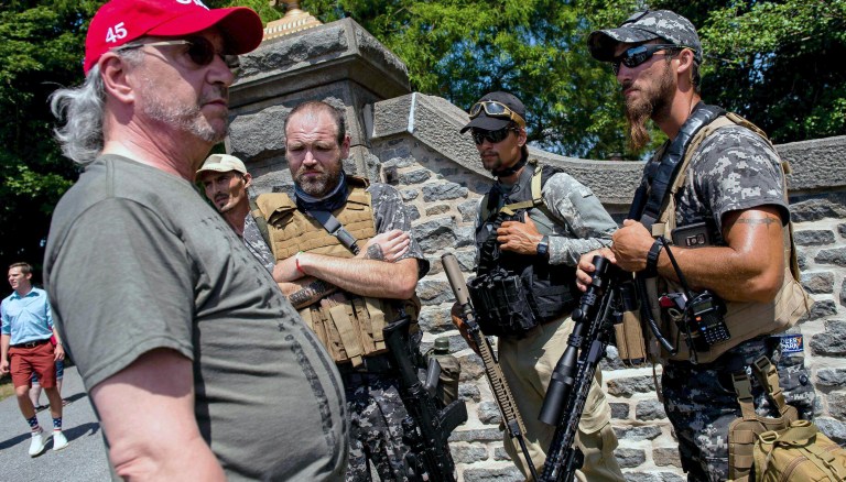 Division over armed militiamen patrolling protest-ridden cities
