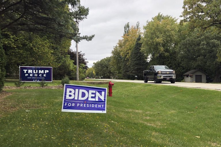 Political signs mark a middle-class neighborhood of Oshkosh, the hub of swing-voting Winnebago County Wisc.