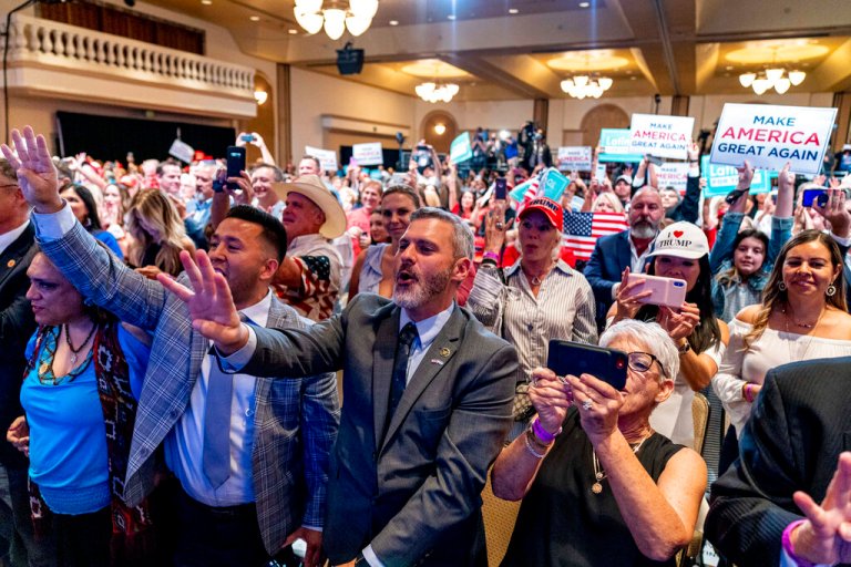 In this Sept. 14, 2020 file photo, supporters react as President Donald Trump speaks at a Latinos for Trump Coalition roundtable at Arizona Grand Resort & Spa in Phoenix.