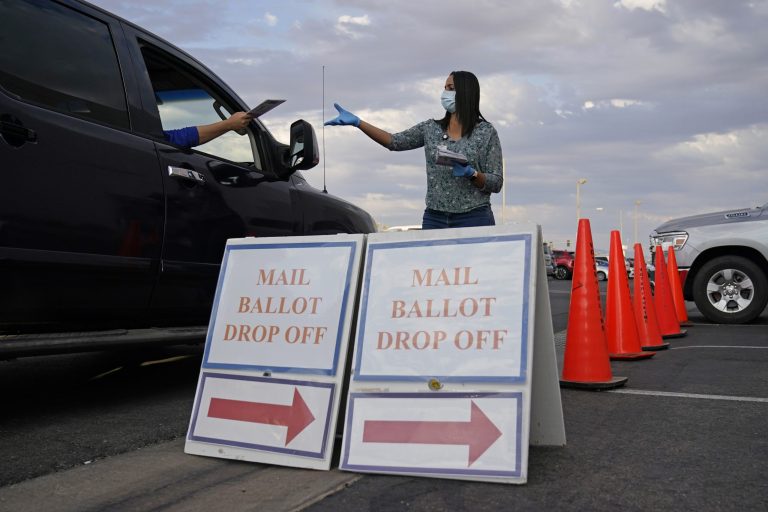 A Clark County, Nev., worker collects mail-in ballots in a drive-thru mail-in ballot drop off area at the Clark County Election Department in Las Vegas. People fear future mail-in counts will lead to more fraud.
