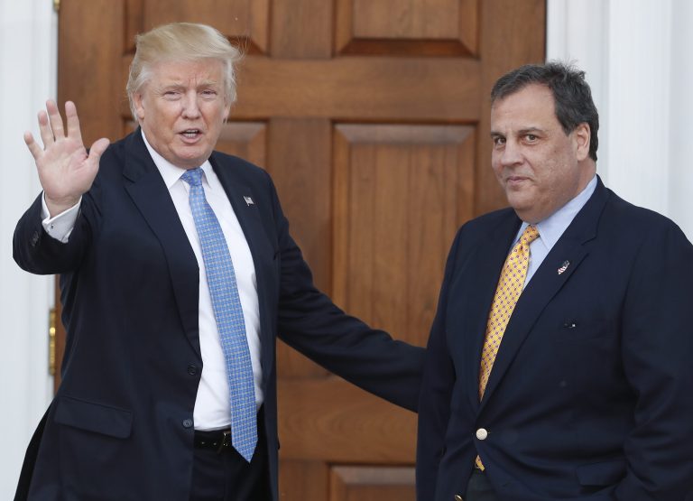 Then President-elect Donald Trump, left, waves to the media as New Jersey Gov. Chris Christie arrives at the Trump National Golf Club Bedminster clubhouse, in Bedminster, N.J., on Nov. 20, 2016. 
