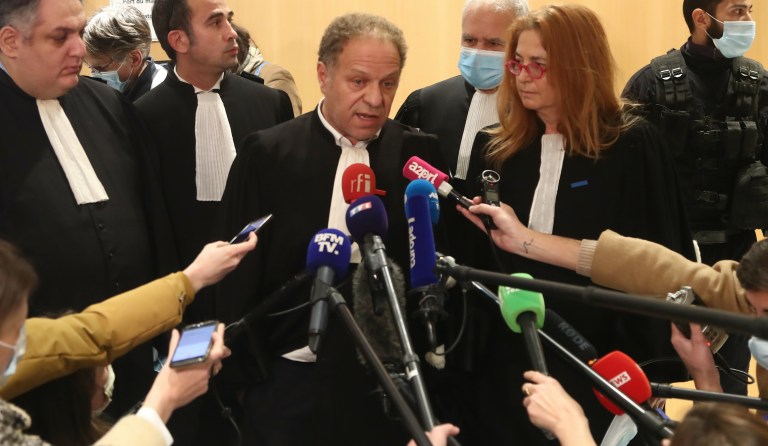 Plaintiffs' lawyer Mehana Mouhou, center, answers reporters after the verdict in the January 2015 Paris attacks trial, Wednesday, Dec.16, 2020 in Paris. The fugitive widow of an Islamic State gunman and a man described as his logistician on Wednesday were convicted of terrorism charges in the trial of 14 people linked to the January 2015 attacks in Paris against the satirical Charlie Hebdo newspaper and a kosher supermarket. The verdict ends the three-month trial linked to the three days of killings across Paris claimed jointly by the Islamic State group and al-Qaida. (AP Photo/Michel Euler)
