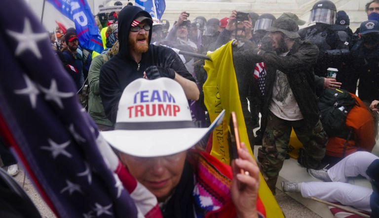 In this Jan. 6, 2021, file photo, rioters try to break through a police barrier, at the Capitol in Washington. 