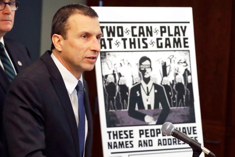 In this Feb. 26, 2020, file photo, Raymond Duda, special agent in charge in Seattle, speaks as he stands next to a poster that was mailed earlier in the year to the home of Chris Ingalls, an investigative reporter with KING-TV in Seattle, during a news conference in Seattle. 