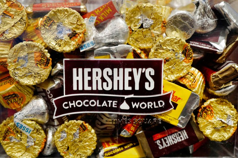 FILE - A mixture of Hershey's chocolates is displayed in the company's Times Square store, Wednesday, March 1, 2017, in New York. Hershey is expanding its salty snack portfolio with the purchase of Dotâs Homestyle Pretzels. The Hershey Co. said Wednesday, Nov. 10, 2021, that it will spend $1.2 billion for North Dakota-based Dotâs Pretzels as well as Pretzels Inc., an Indiana-based manufacturer of Dotâs Pretzels that operates three plants.
