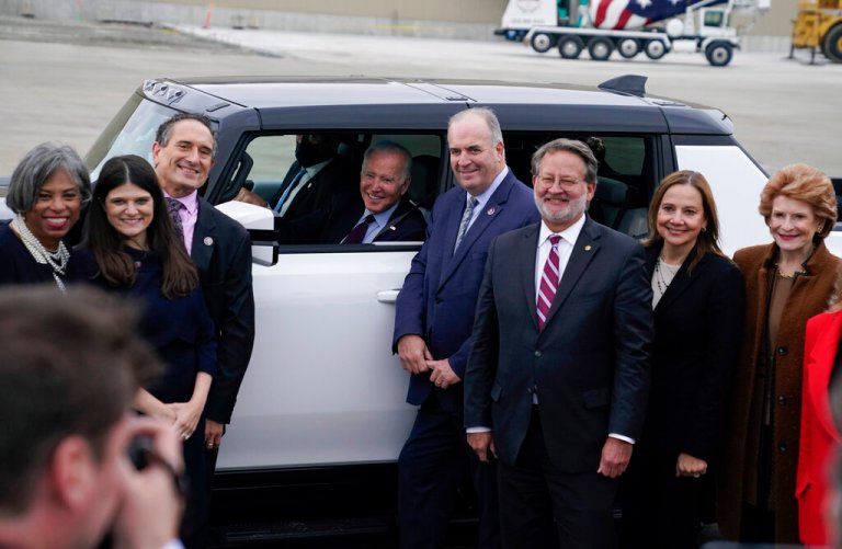 President Joe Biden poses for a photo after test driving a Hummer at the General Motors Factory ZERO electric vehicle assembly plant during a tour Wednesday, Nov. 17, 2021, in Detroit. From left, Rep. Brenda Lawrence, D-Mich., Rep. Haley Stevens, D-Mich., Rep. Andy Levin, D- Mich., Biden, Rep. Dan Kildee, D-Mich., Sen. Gary Peters, D-Mich., General Motors CEO Mary Barra and Sen. Debbie Stabenow, D-Mich. 