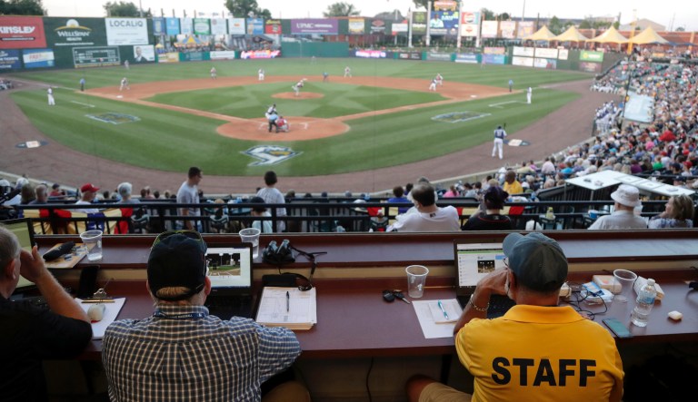 Ron Besaw, right, operates a laptop computer as home plate umpire Brian deBrauwere, gets signals from a radar with the ball and strikes calls during the fourth inning of the Atlantic League All-Star minor league baseball game, Wednesday, July 10, 2019, in York, Pa.