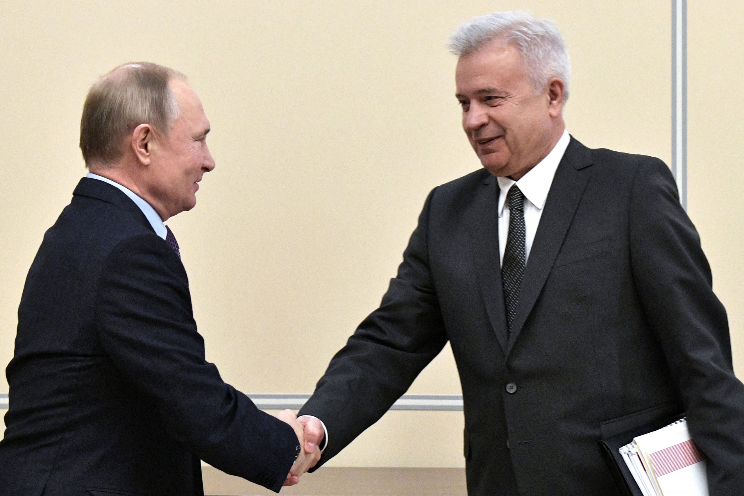 Russian President Vladimir Putin, left, shakes hands with Lukoil President Vagit Alekperov during a meeting at the Novo-Ogaryovo residence outside Moscow on Jan. 28, 2020.