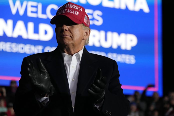 FILE - Former President Donald Trump arrives at a rally, March 12, 2022, in Florence, S.C. Trump wants to use November's midterm elections to solidify his continued dominance of the national Republican Party. Enraged that Republican Gov. Brian Kemp didn't advance lies that the state's free and fair presidential election was stolen, Trump recruited former Sen. David Perdue to run against him in the May 24 primary. (AP Photo/Meg Kinnard, File)