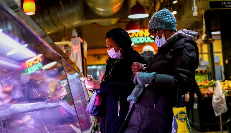 Customers wear face masks to protect against the spread of the coronavirus as they shop at the Reading Terminal Market in Philadelphia, Feb. 16, 2022. Philadelphia is reinstating its indoor mask mandate after reporting a sharp increase in coronavirus infections, Dr. Cheryl Bettigole, the city's top health official, announced Monday, April 11, 2022. 