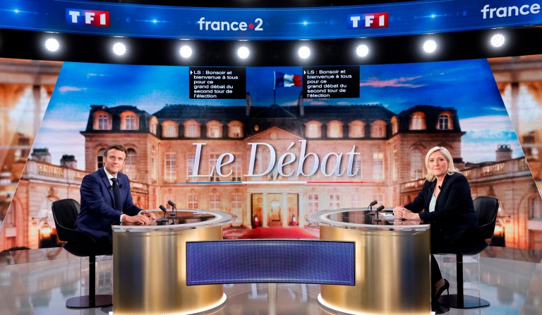 Centrist candidate and French President Emmanuel Macron (left) and far-right contender Marine Le Pen pose before a televised debate in La Plaine-Saint-Denis, France, on Wednesday.