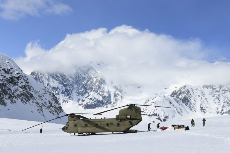 Army grounds Chinook helicopter fleet Personnel offload equipment and supplies from a CH-47 Chinook helicopter in Alaska.