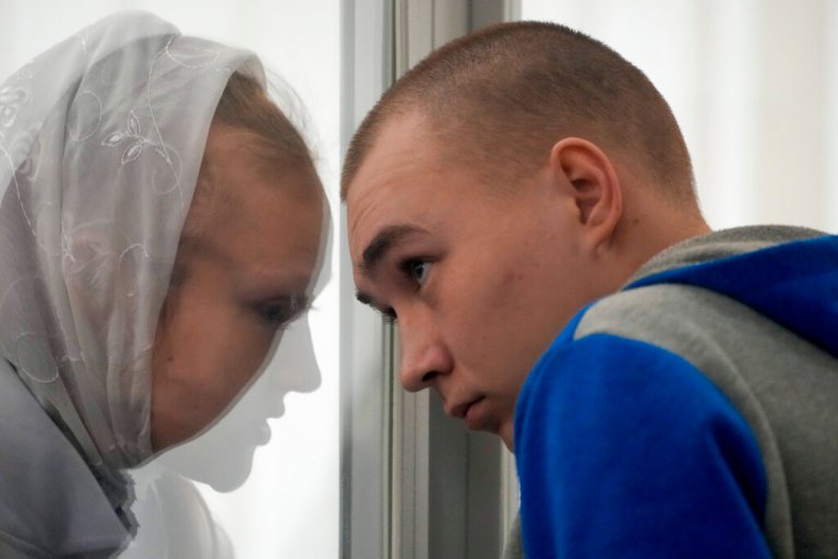 Russian Sgt. Vadim Shishimarin listens to his translator during a court hearing in Kyiv, Ukraine, Monday, May 23, 2022.