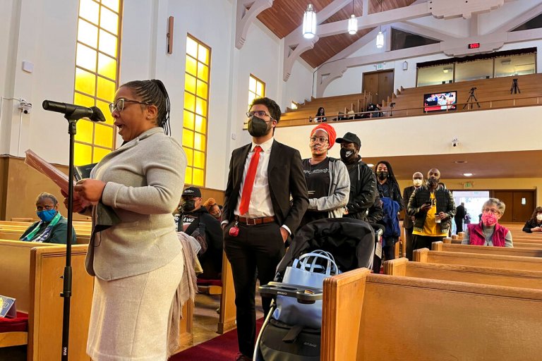 FILE - People line up to speak during a reparations task force meeting at Third Baptist Church in San Francisco.