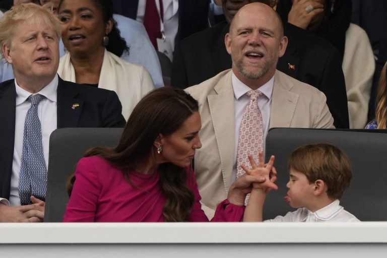 Kate, the Duchess of Cambridge, left, and Prince Louis attend the Platinum Jubilee Pageant. British Prime Minister Boris Johnson and Mike Tindall are seated in the background.