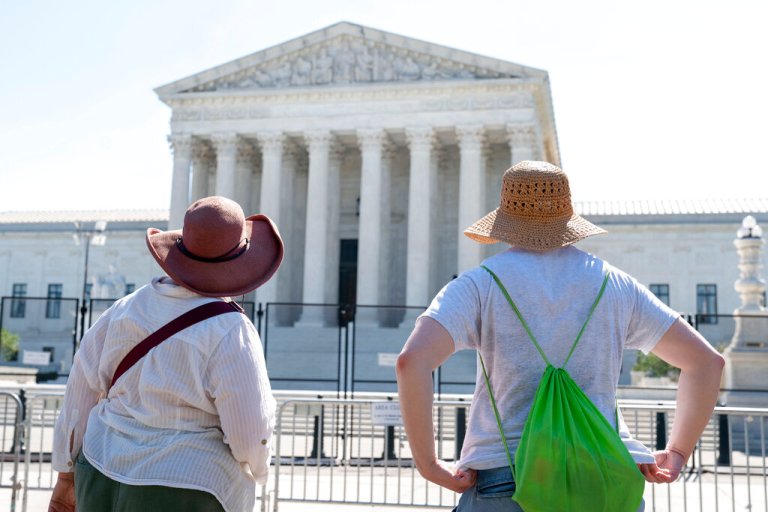Women in sunhats look at the Supreme Court, Thursday, June 30, 2022, in Washington. 