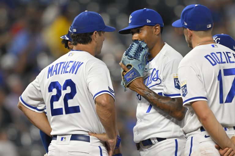 Kansas City Royals manager Mike Matheny (22) talked to relief pitcher Jose Cuas (74) during Tuesday's baseball game against the Detroit Tigers. Matheny said 10 of his players, including Hunter Dozier (17), will not make the team's trip to Toronto, Canada for its four-game series this weekend.